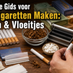 Hand rolling cigarette with hulzen, tobacco, and vloeitjes on wooden table.