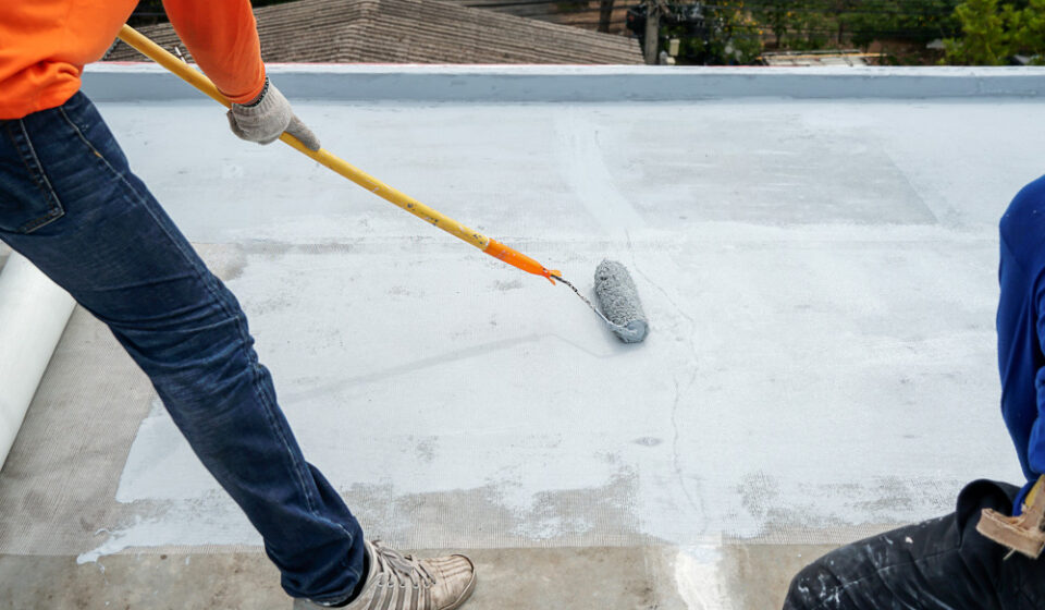 man waterproofing a building
